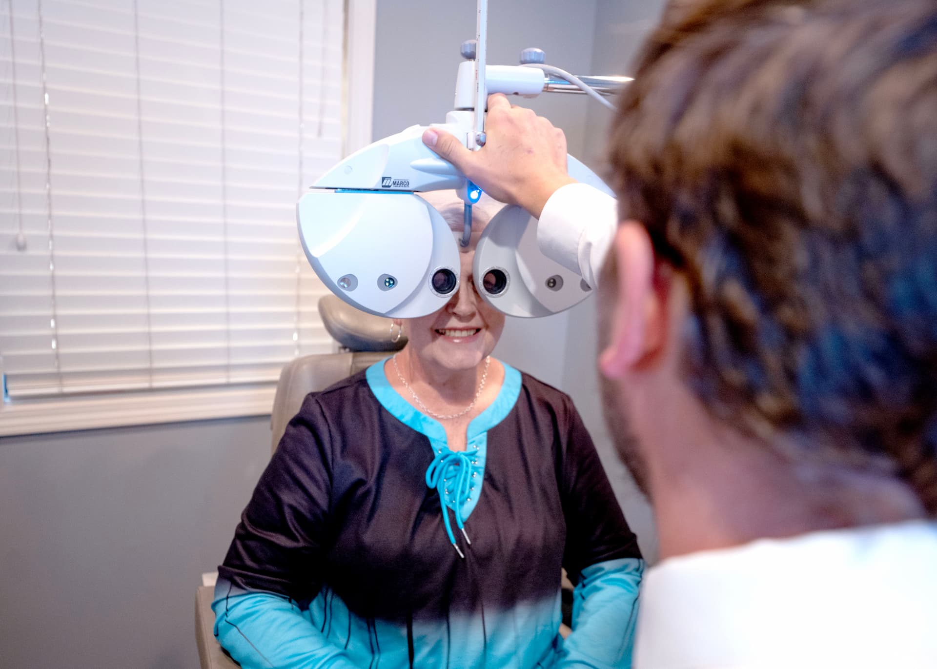 Dr. Dunnam performing eye exam on elderly lady